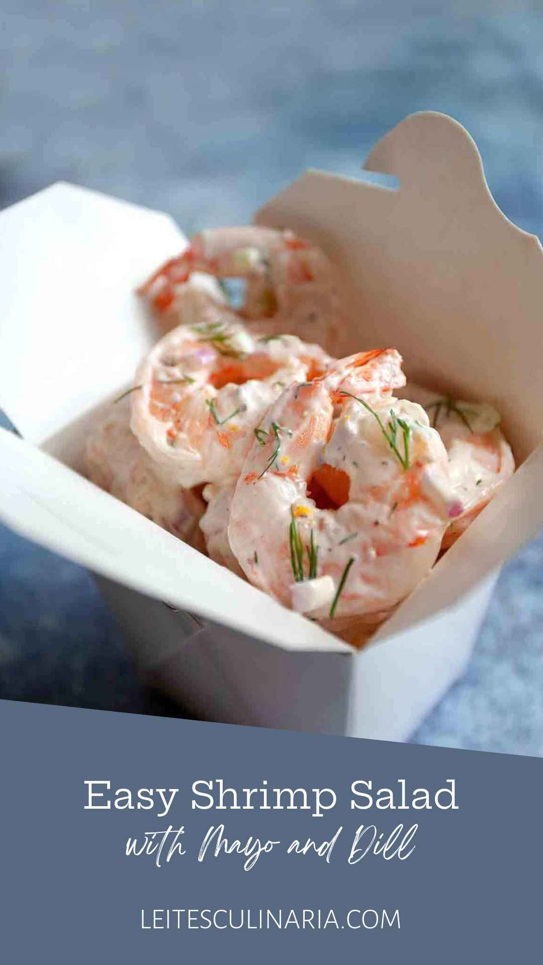 Creamy shrimp salad with fresh dill in a white takeout container.