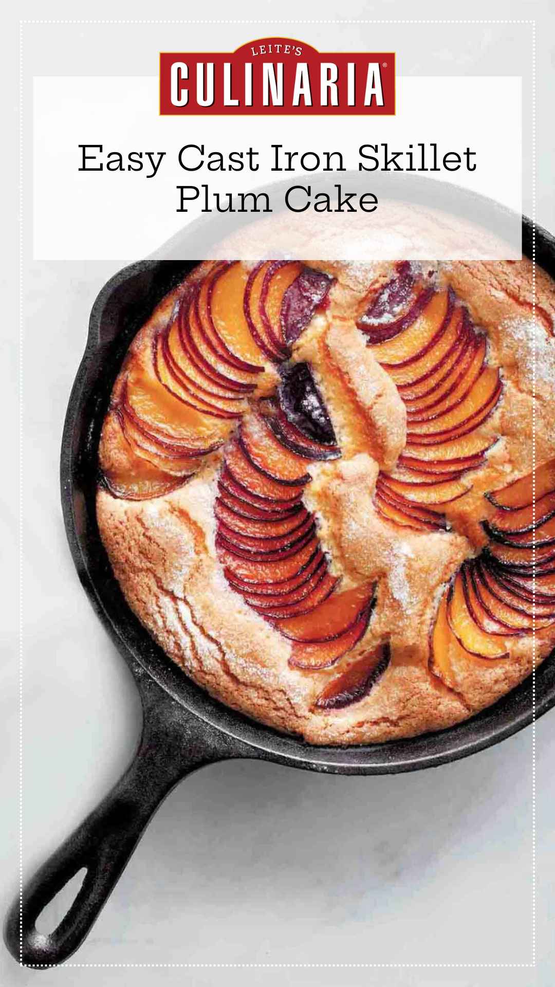 A cake in a cast iron skillet with sliced plums fanned across the surface and baked into the cake.