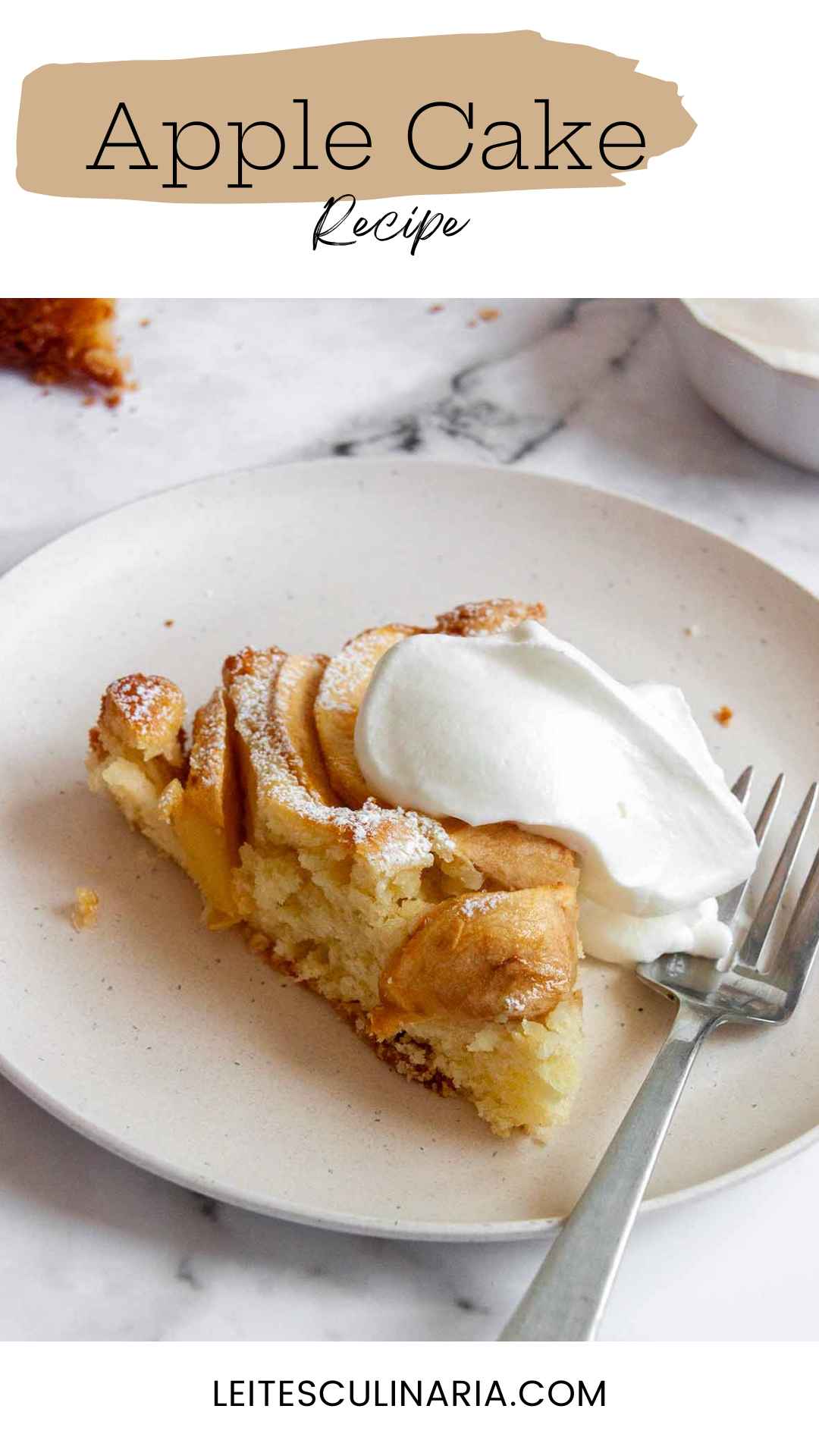 A slice of apple cake topped with whipped cream.