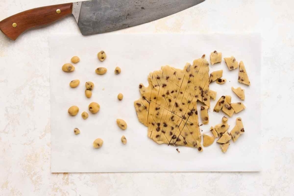 Chocolate chip cookie dough scored into pieces and rolled into balls.