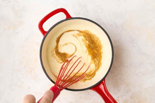 Vanilla being whisked into a ice cream custard.