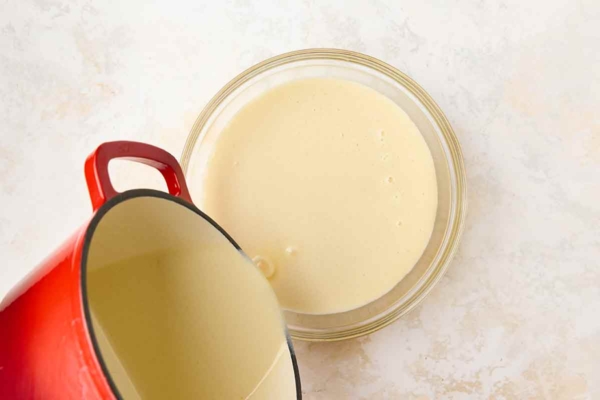 Ice cream custard being poured into a bowl.