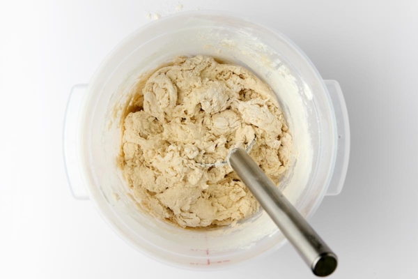 Bread dough in a large container.