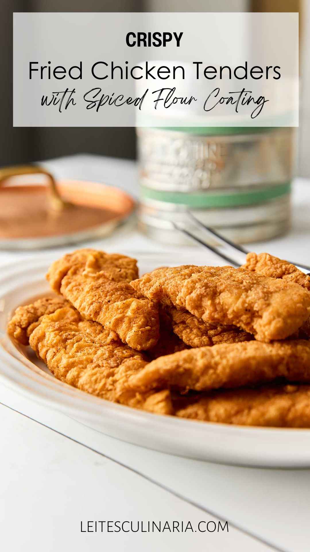 A white oval platter of pan-fried chicken tenders.