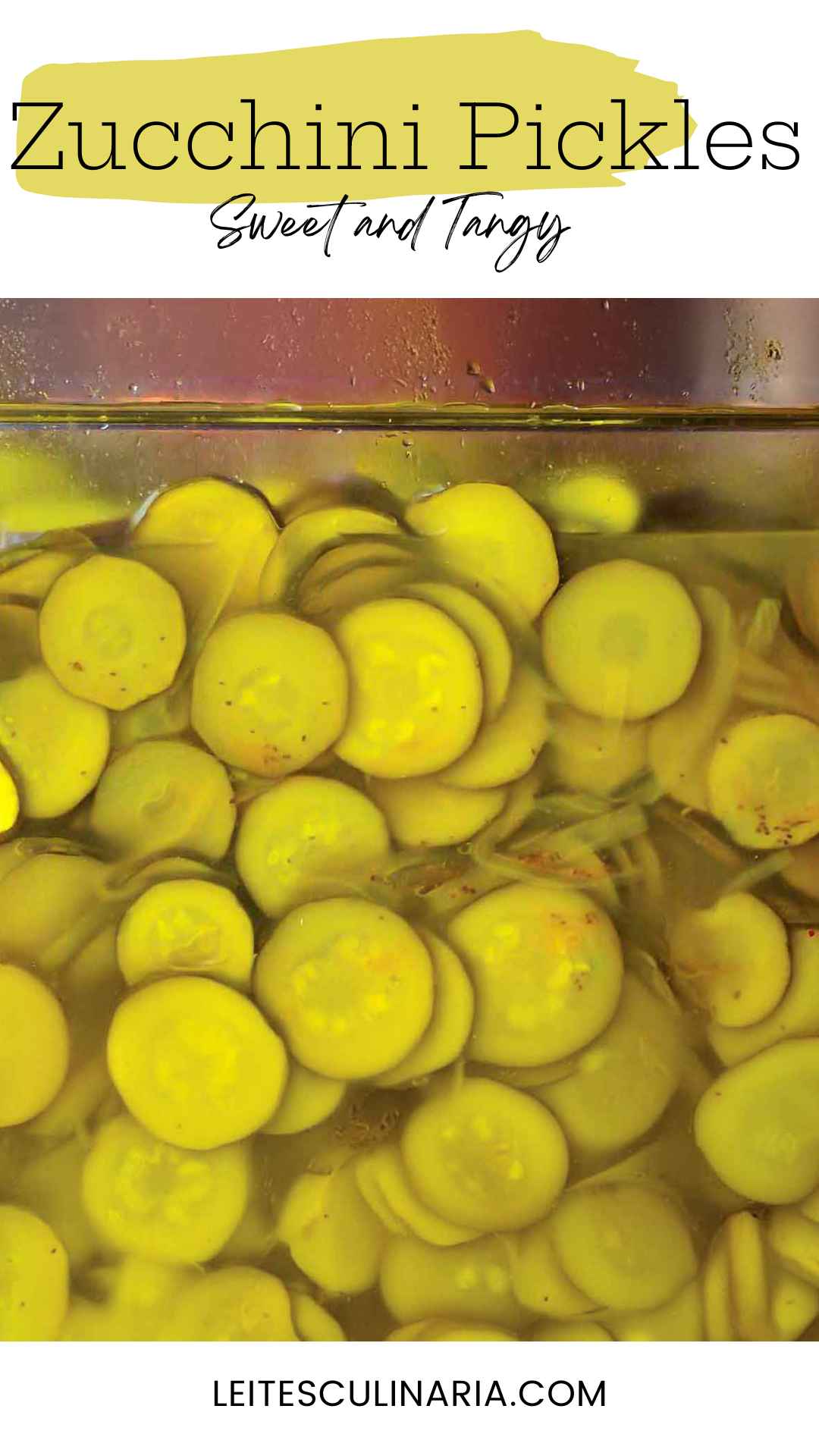 A glass jar filled with pickled zucchini slices in brine.