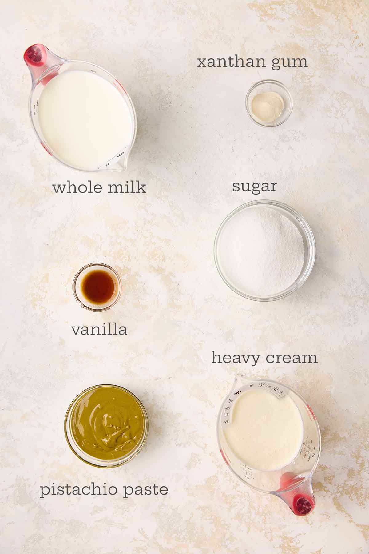 The ingredients for pistachio gelato: milk, cream, pistachio paste, sugar, xanthan gum, and vanilla extract.