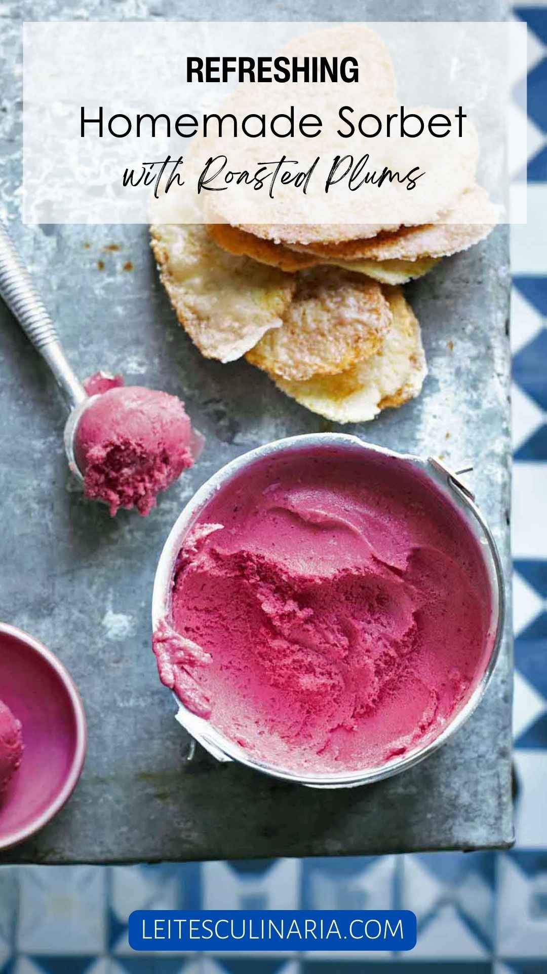 A small bucket of plum sorbet with a scoop of sorbet in a metal ice cream scoop nearby.