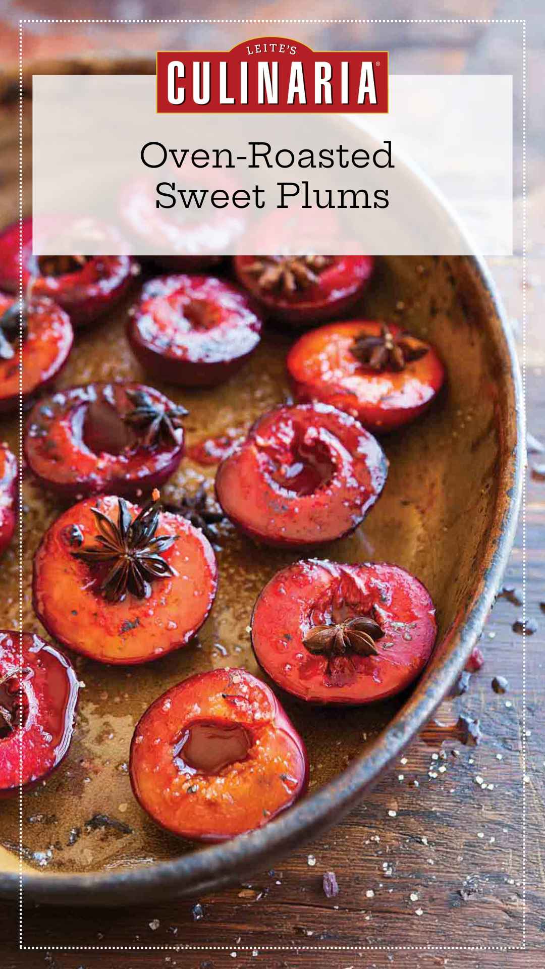 A metal baking dish filled with roasted plum halves that are topped with star anise.