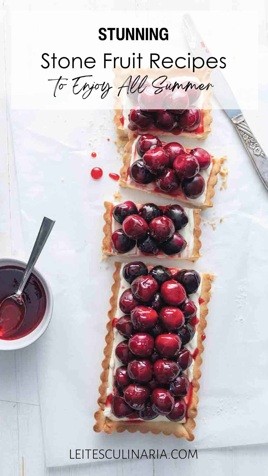 A rectangular fresh cherry tart cut into pieces.