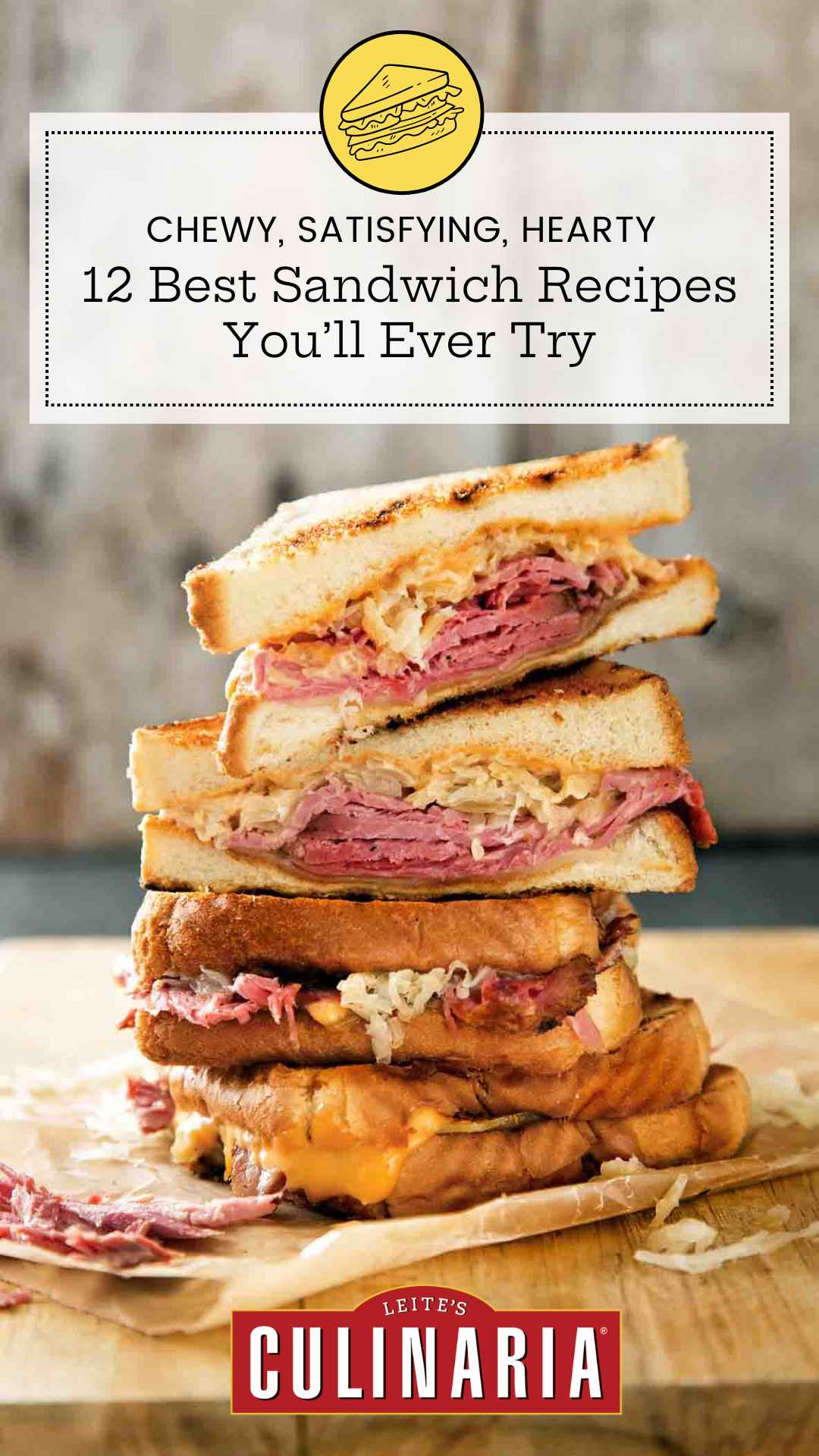 Quartered sections of a reuben sandwich stacked on top of each other on a wooden cutting board.