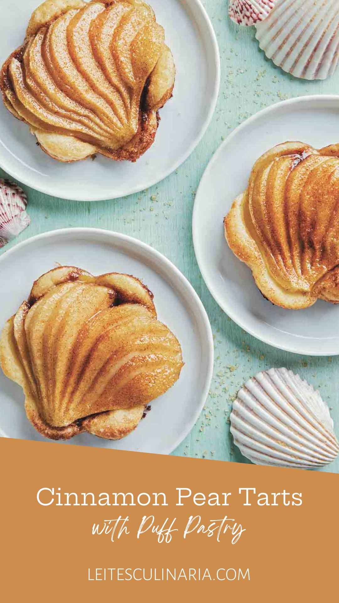 Three individual pear tarts with puff pastry on white plates.