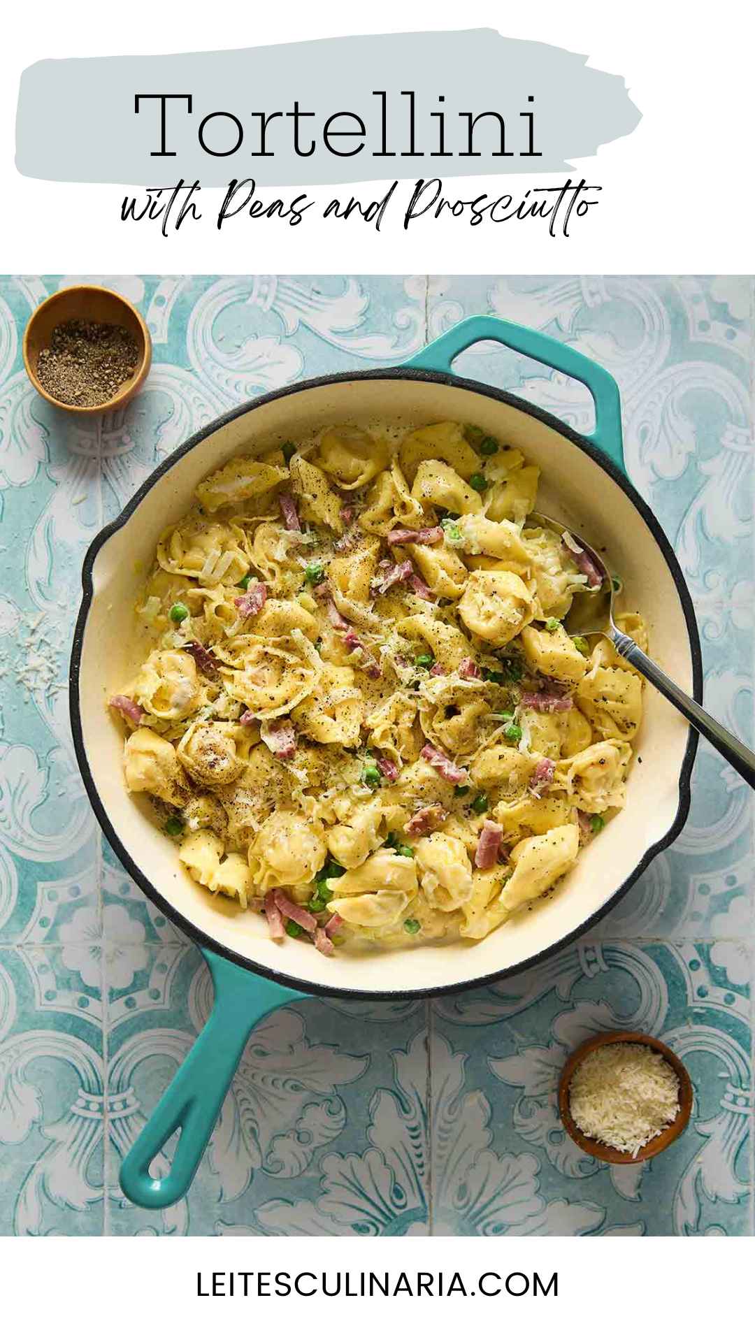 A deep skillet filled with tortellini with peas and prosciutto with bowls of pepper and cheese on the side.