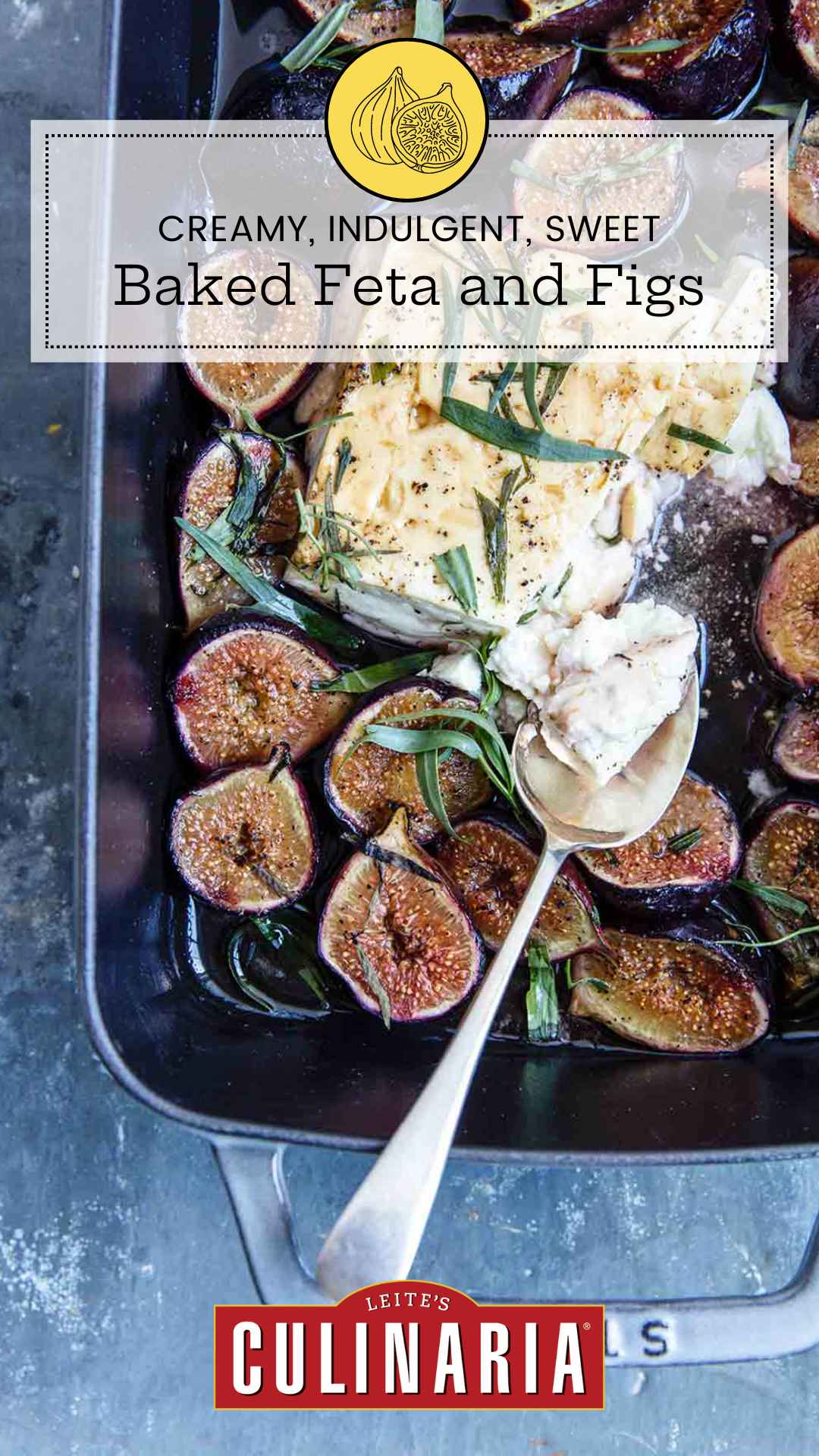 A rectangular baking dish filled with baked feta and figs, topped with fresh tarragon leaves.