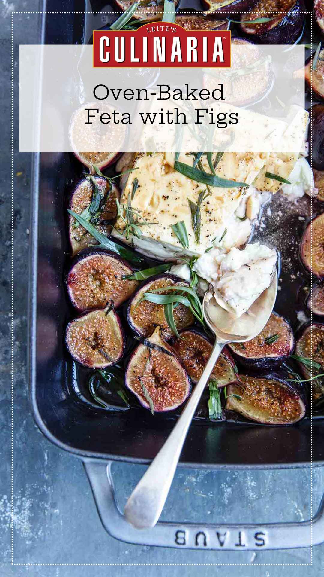 A rectangular baking dish filled with baked feta and figs, topped with fresh tarragon leaves.