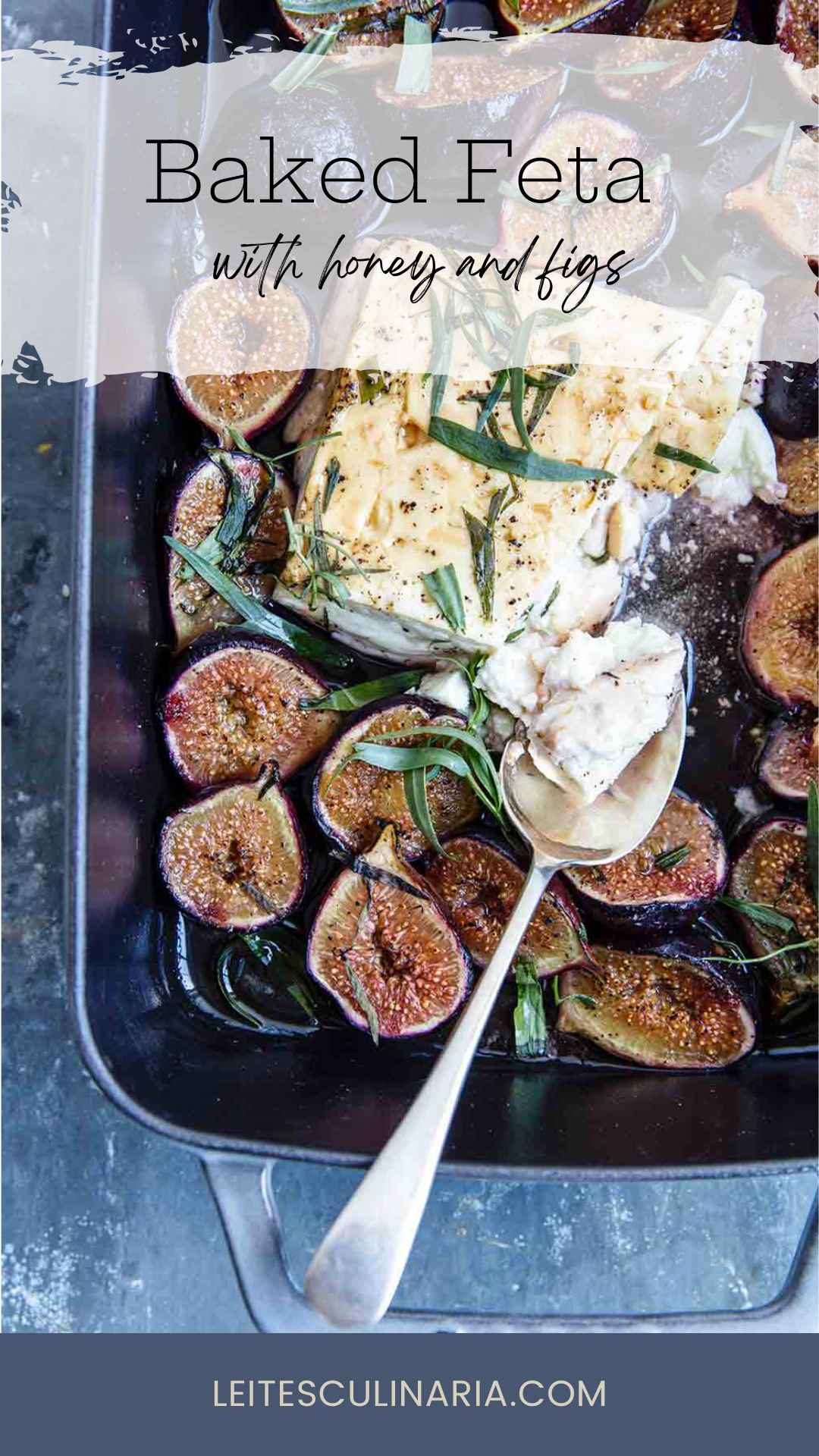 A rectangular baking dish filled with baked feta and figs, topped with fresh tarragon leaves.