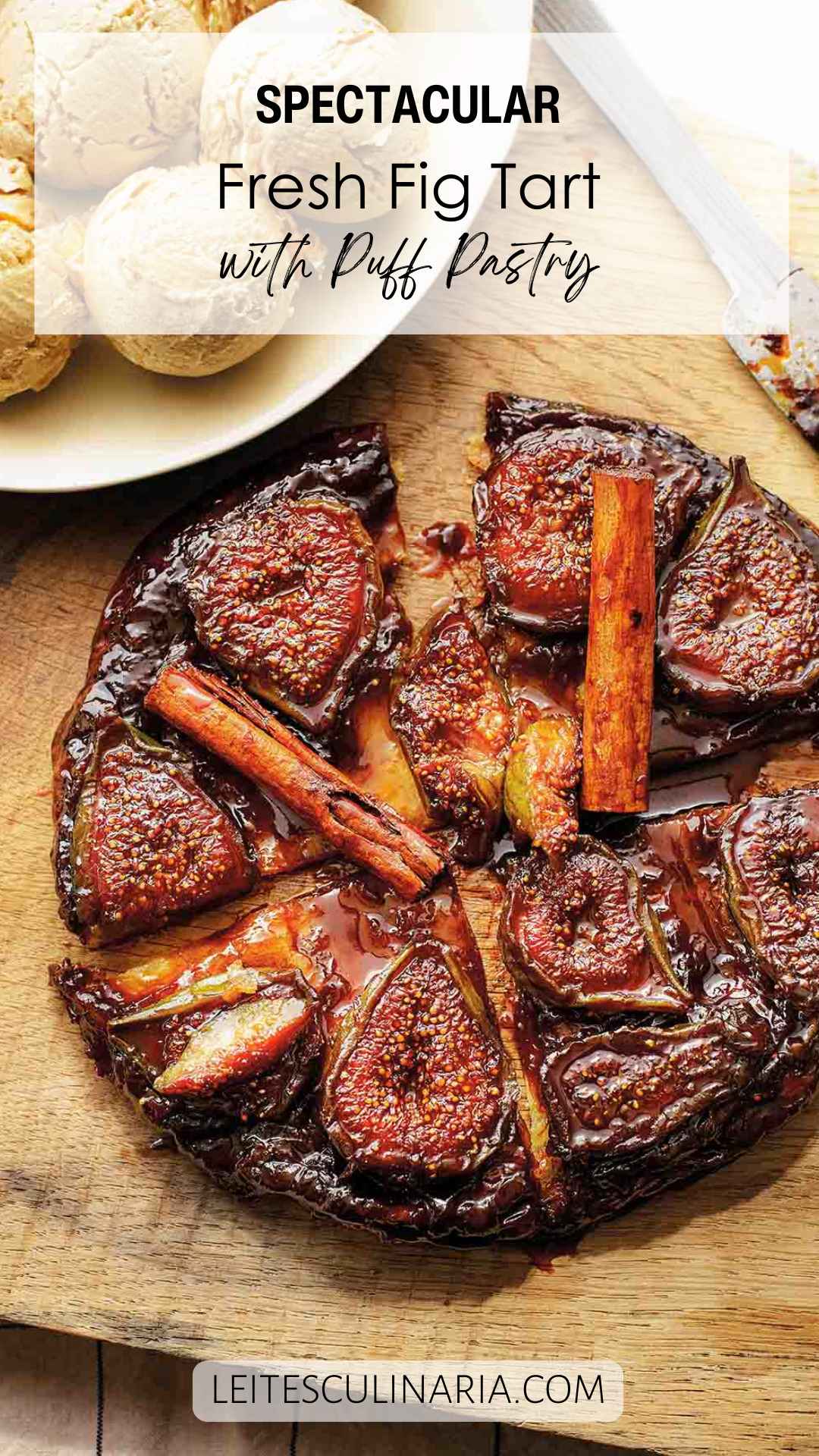 A whole fig tarte tatin topped with whole cinnamon sticks and cut into several pieces.