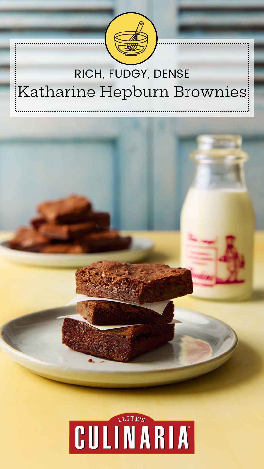 Three brownies stacked on a plate with a bottle of milk in the background.