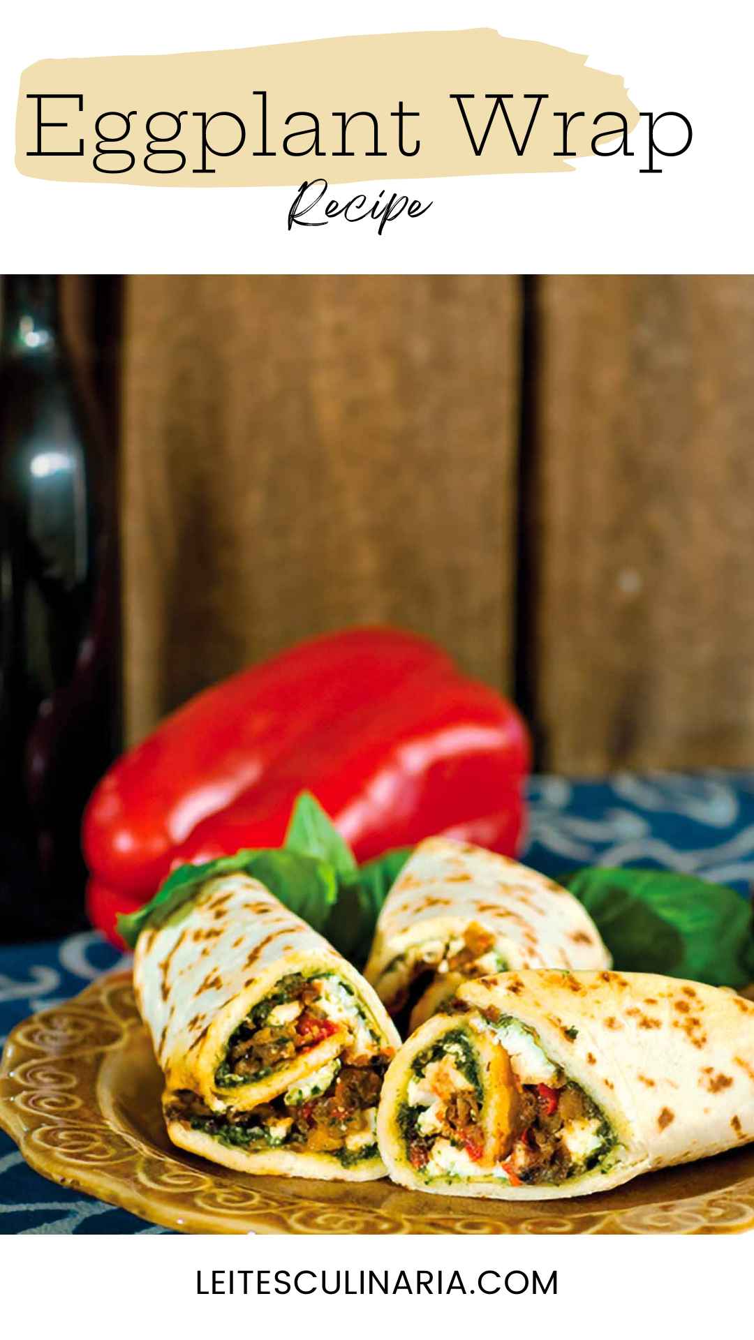 Three Mediterranean eggplant wraps on a plate with a whole red pepper in the background.