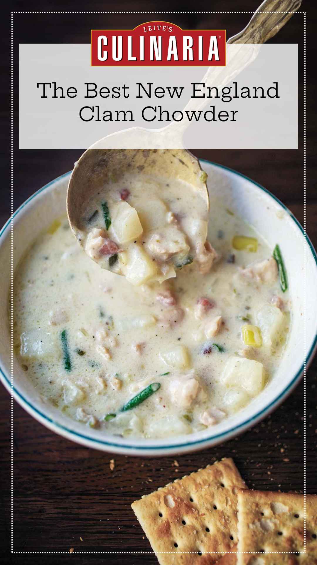 A bowl of New England clam chowder with a spoon scooping some out.