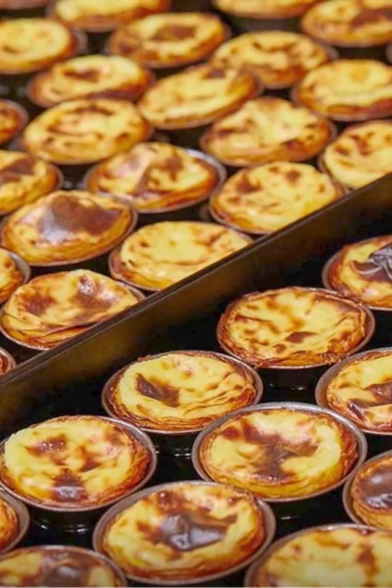 Two trays filled with pasteis de nata (pastel de nata)