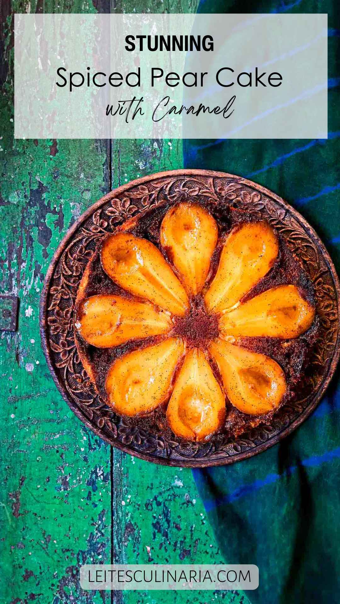 A pear upside-down cake with eight visible pear halves on a decorative plate.