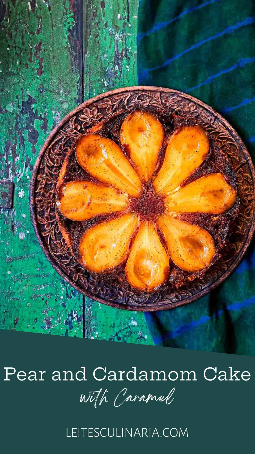 A pear upside-down cake with eight visible pear halves on a decorative plate.