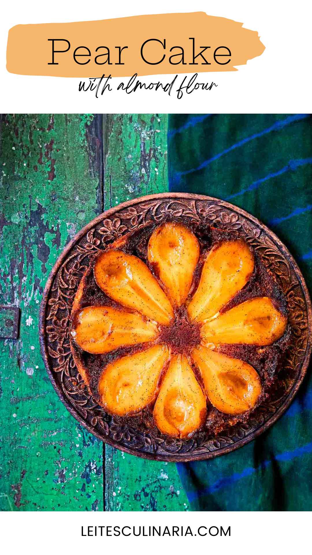 A pear upside-down cake with eight visible pear halves on a decorative plate.