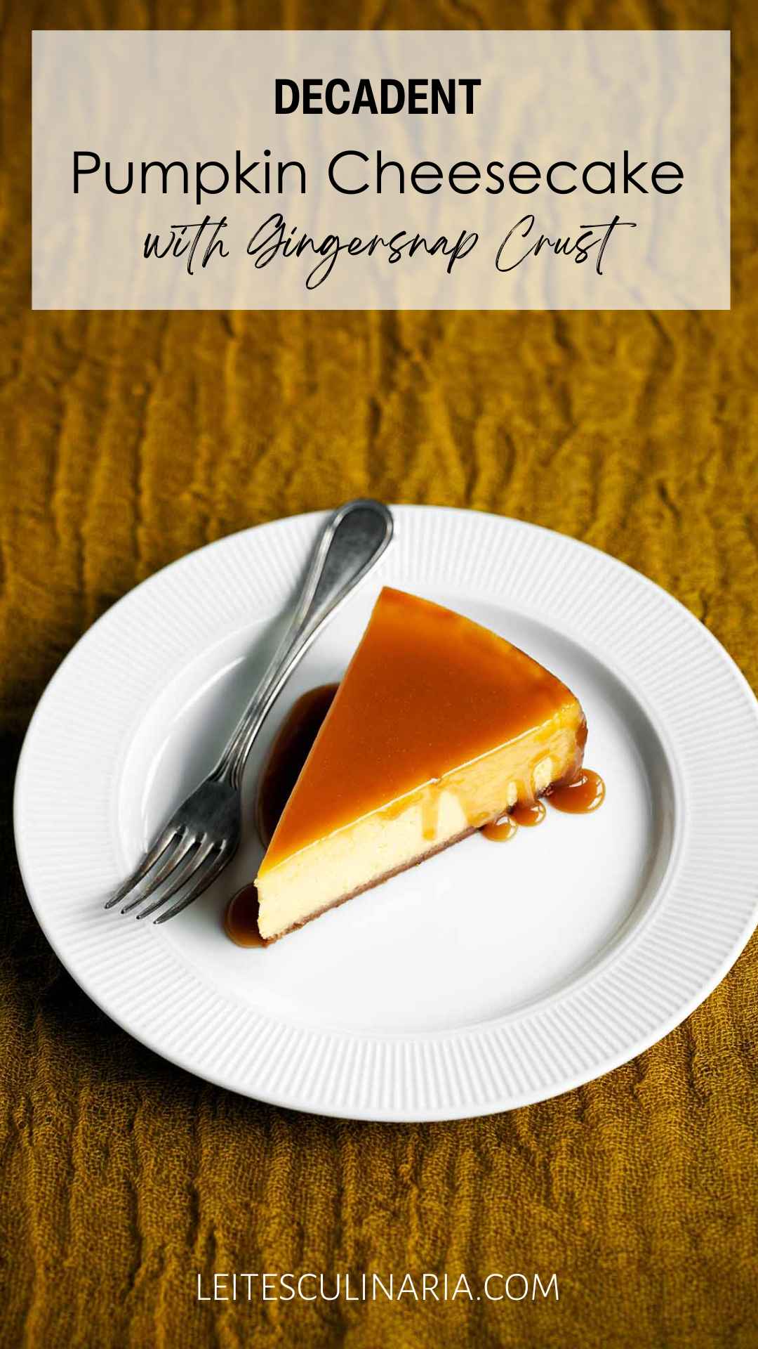 A slice of pumpkin cheesecake with caramel glaze drizzled over the top on a white plate with a fork on the side.