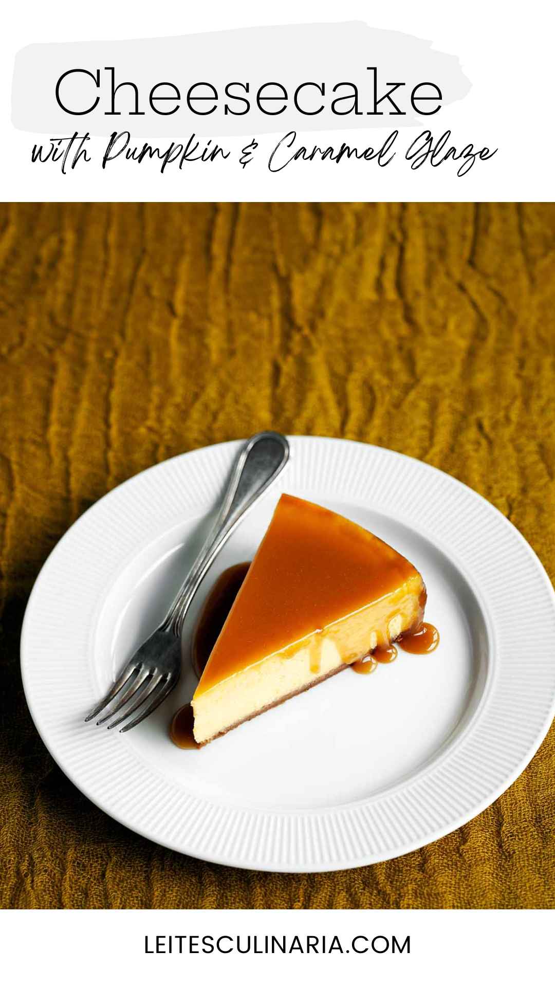 A slice of pumpkin cheesecake with caramel glaze drizzled over the top on a white plate with a fork on the side.