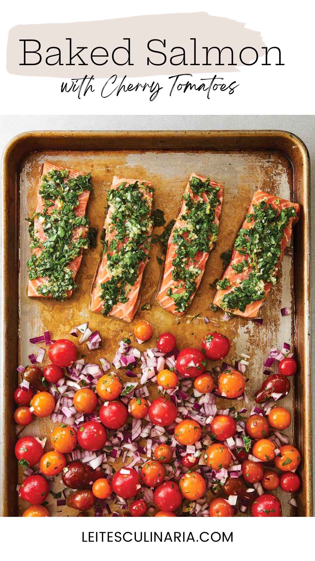 A baking sheet with four filets of salmon topped with a herb mixture, and a mixture of cherry tomatoes and red onion on the rest of the sheet.