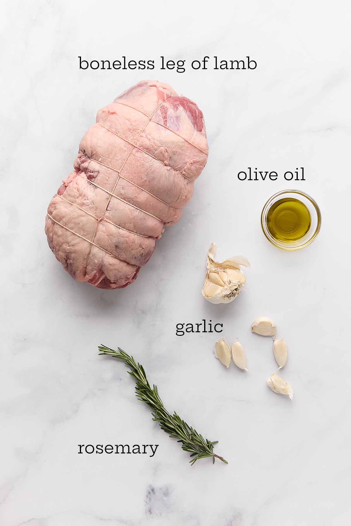 Ingredients for slow-roasted boneless leg of lamb--lamb, olive oil, garlic, and rosemary.