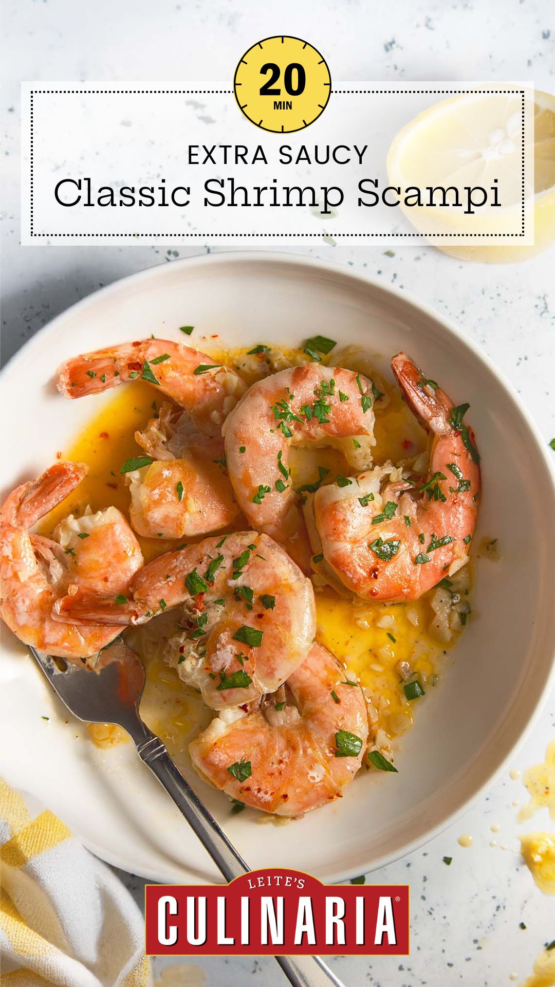 A white plate of shrimp scampi in a buttery garlic sauce, topped with chopped parsley and served with a lemon wedge.