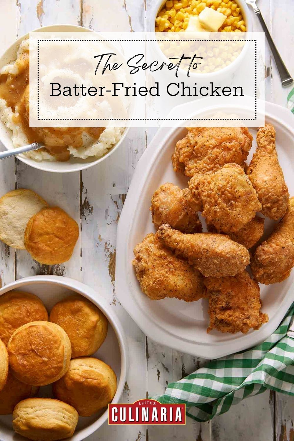 A platter of batter-fried chicken served with biscuits, mashed potatoes, and corn.