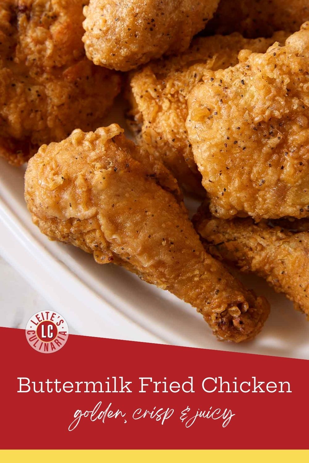 A close-up of crispy, deep-fried chicken with a golden crust, served on a plate.