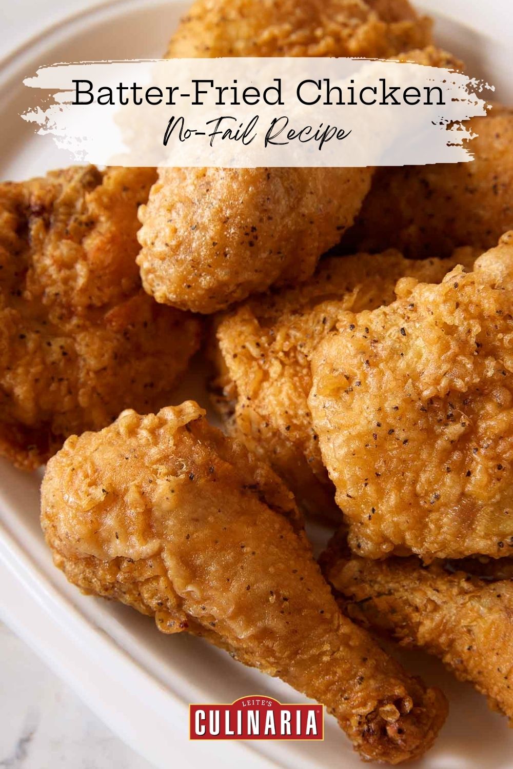 Close-up of golden buttermilk fried chicken with visible crispy texture and seasoning.