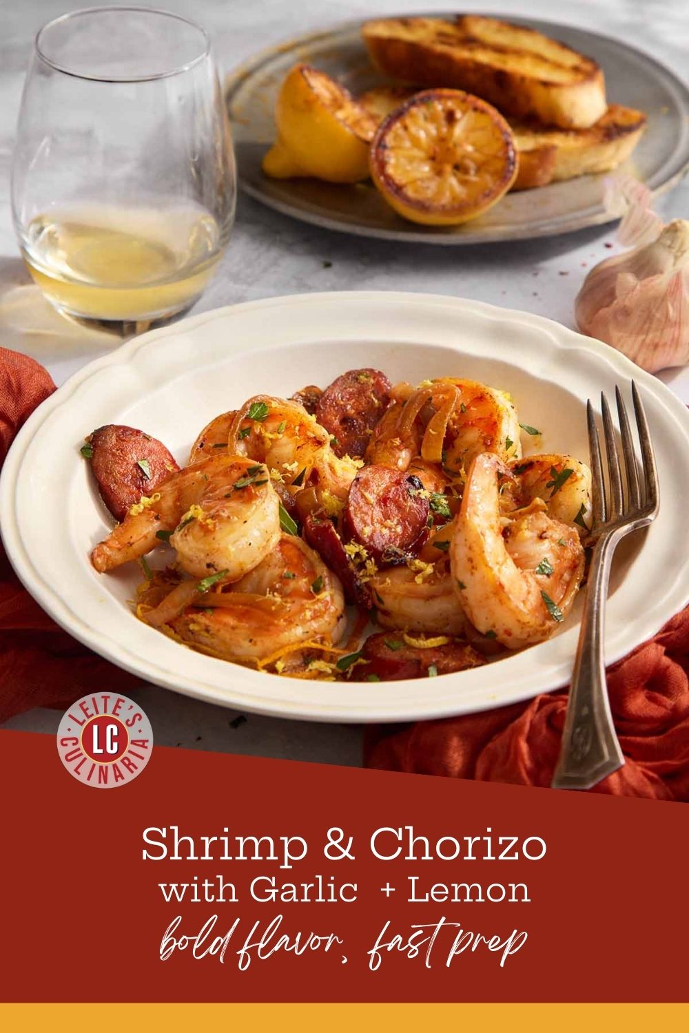 Shrimp and chorizo with charred lemon and toast in the background, ready to serve.