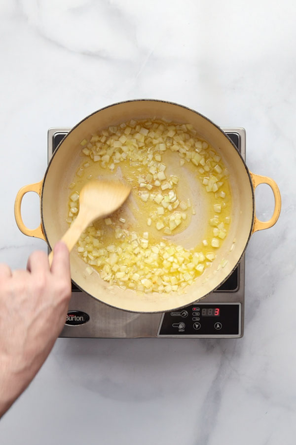 Onions sautéing in butter and oil in a large Dutch oven for Bolognese sauce.