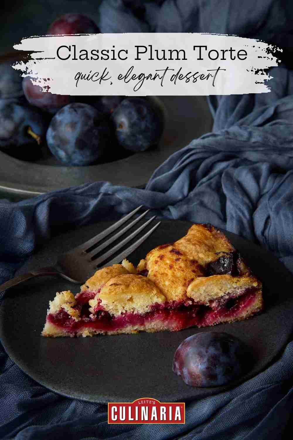 The classic NY Times plum torte for a on a black plate on blue fabric.