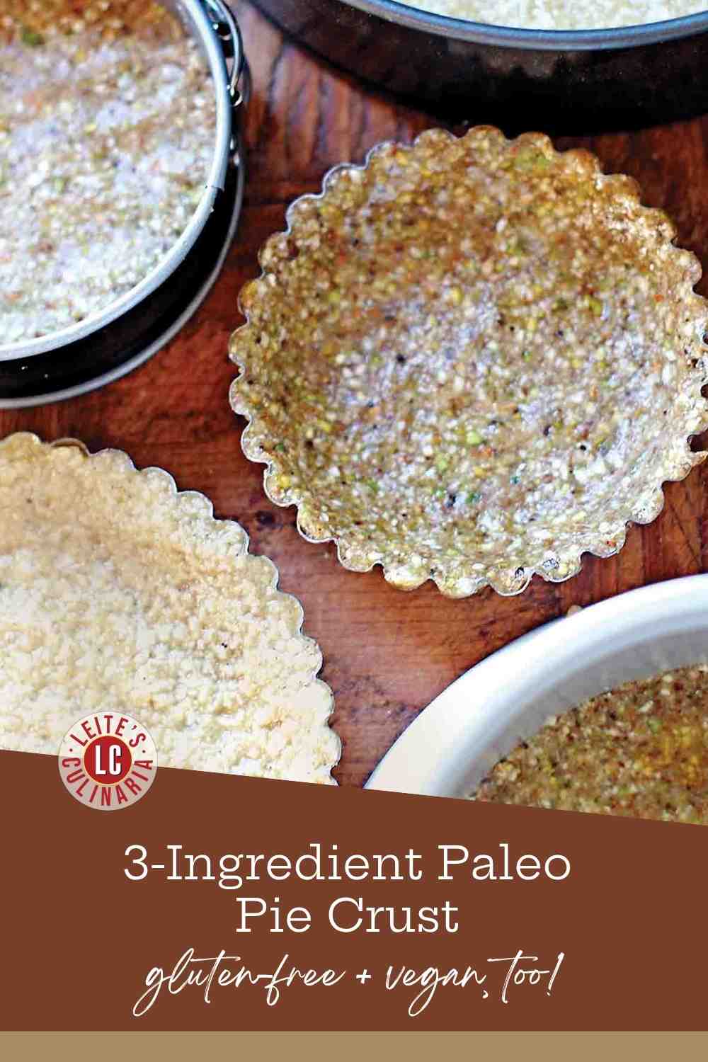 Raw paleo pie crust made from ground nuts and dates pressed into the bottom of a metal pie plate.