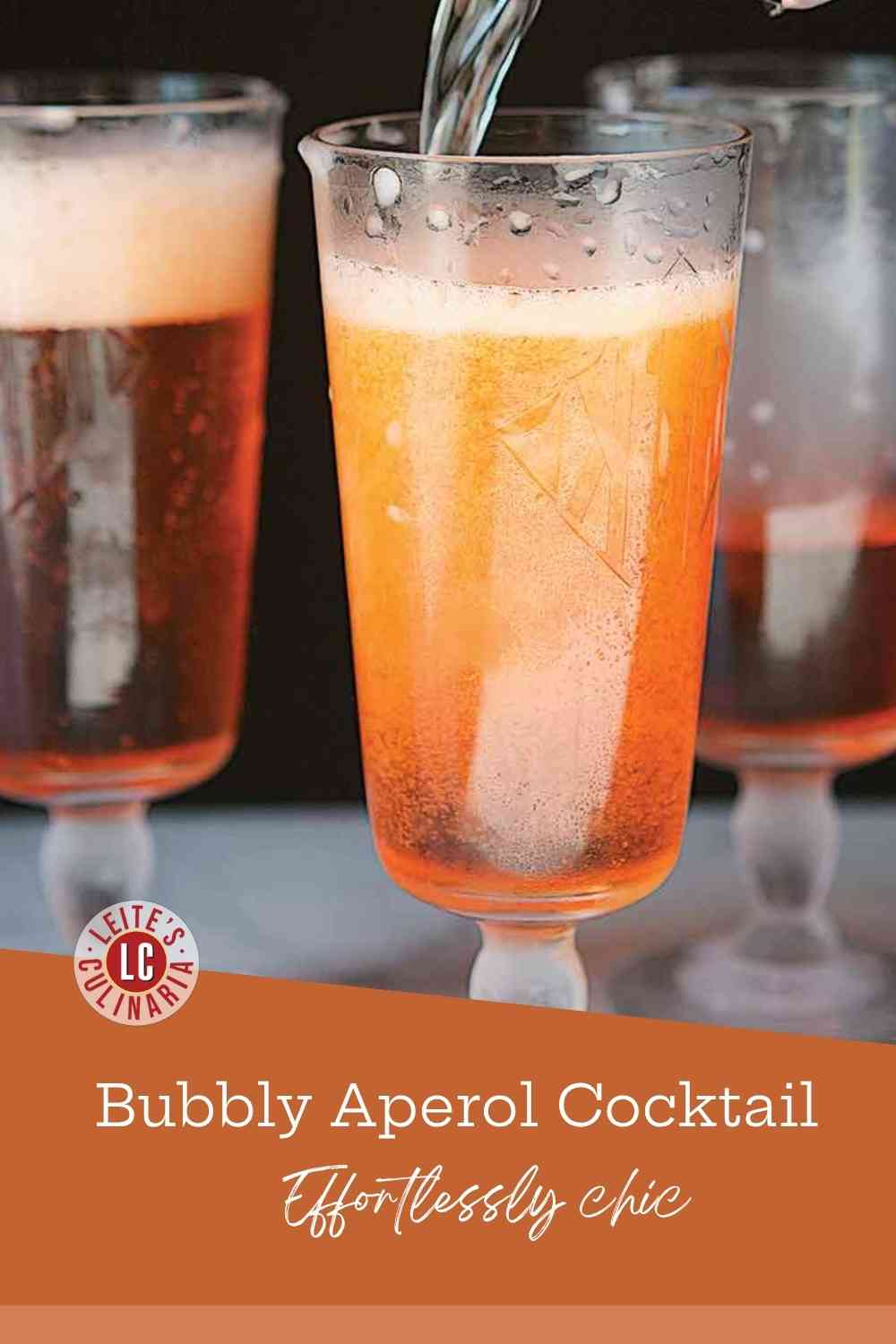 Sparkling Prosecco being poured into a flute glass already filled with vibrant orange Aperol.