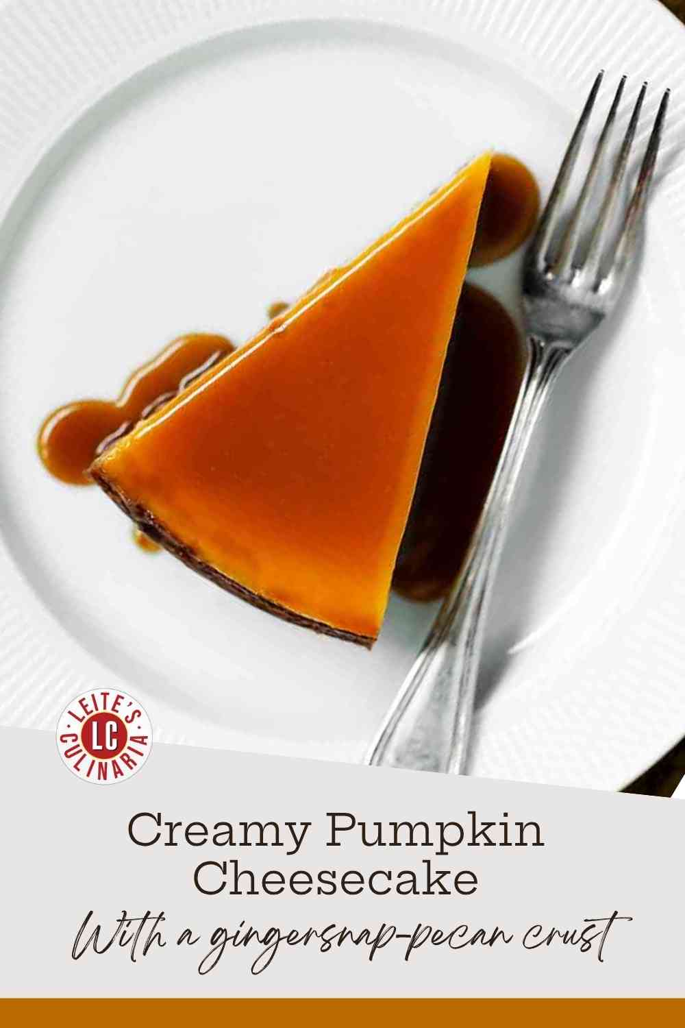 A glossy slice of pumpkin cheesecake on a white plate, drizzled with a rich amber caramel sauce, against a golden-ochre background.