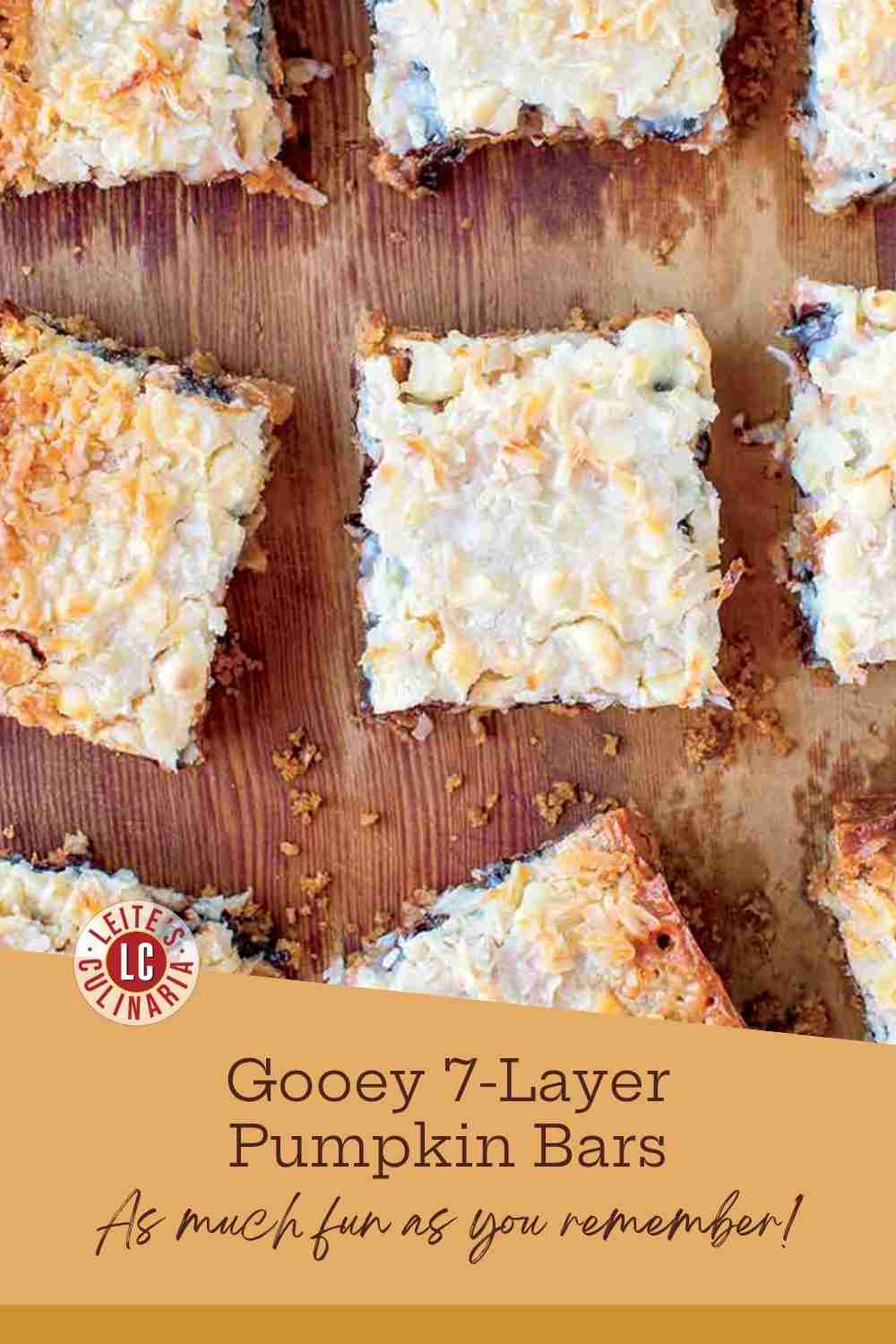 Stack of gooey pumpkin seven layer bars showing graham crust, pumpkin filling, chocolate chips, and toasted coconut.