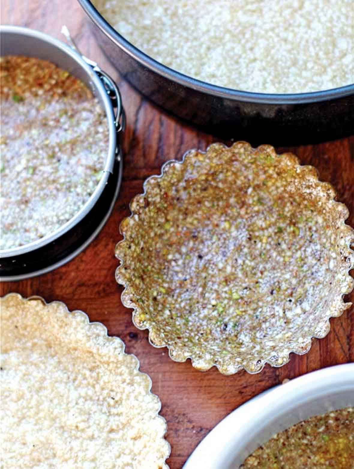 Several paleo pie crusts made from nuts, dried fruit, and vanilla.