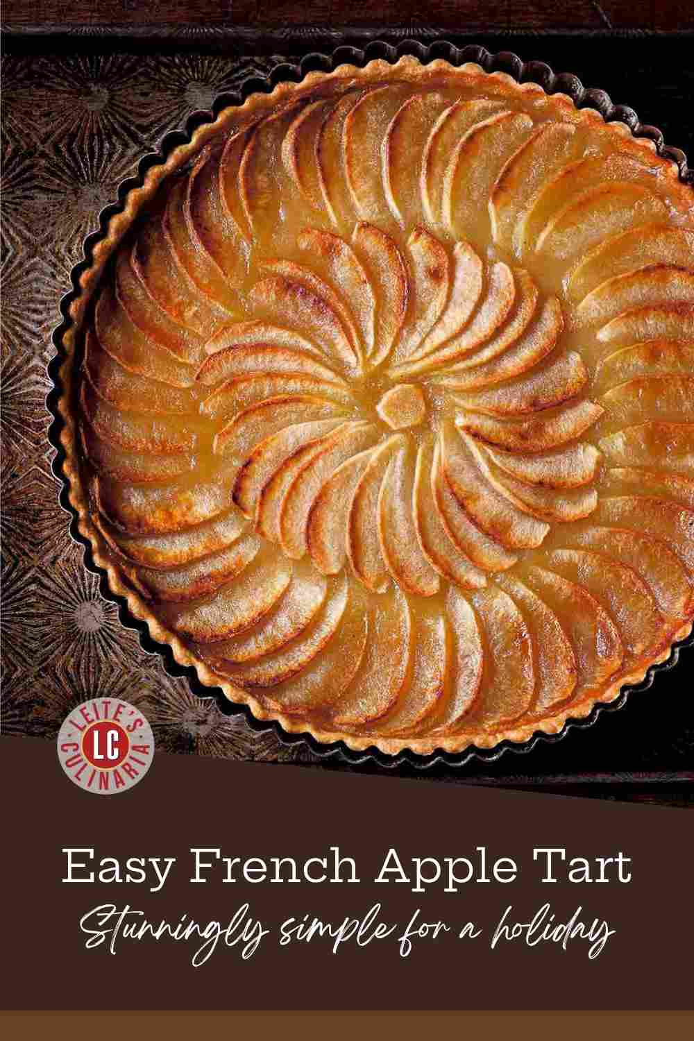 Golden-brown French apple tart with a buttery crust and thinly sliced apples arranged in a neat, concentric circle.