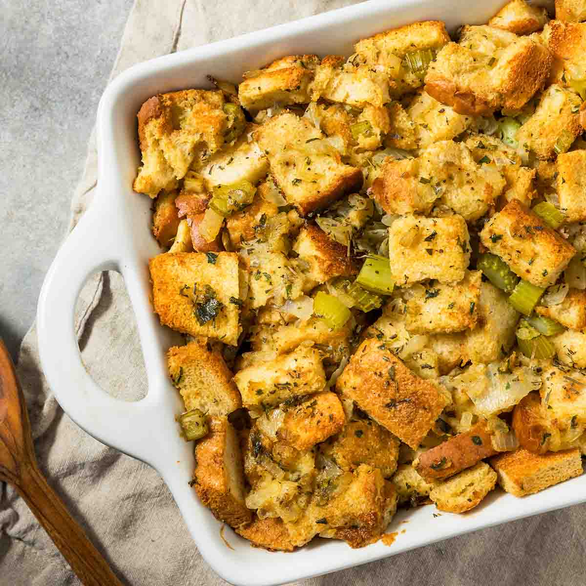 A casserole dish of bread stuffing with celery and seasoned with herbs.