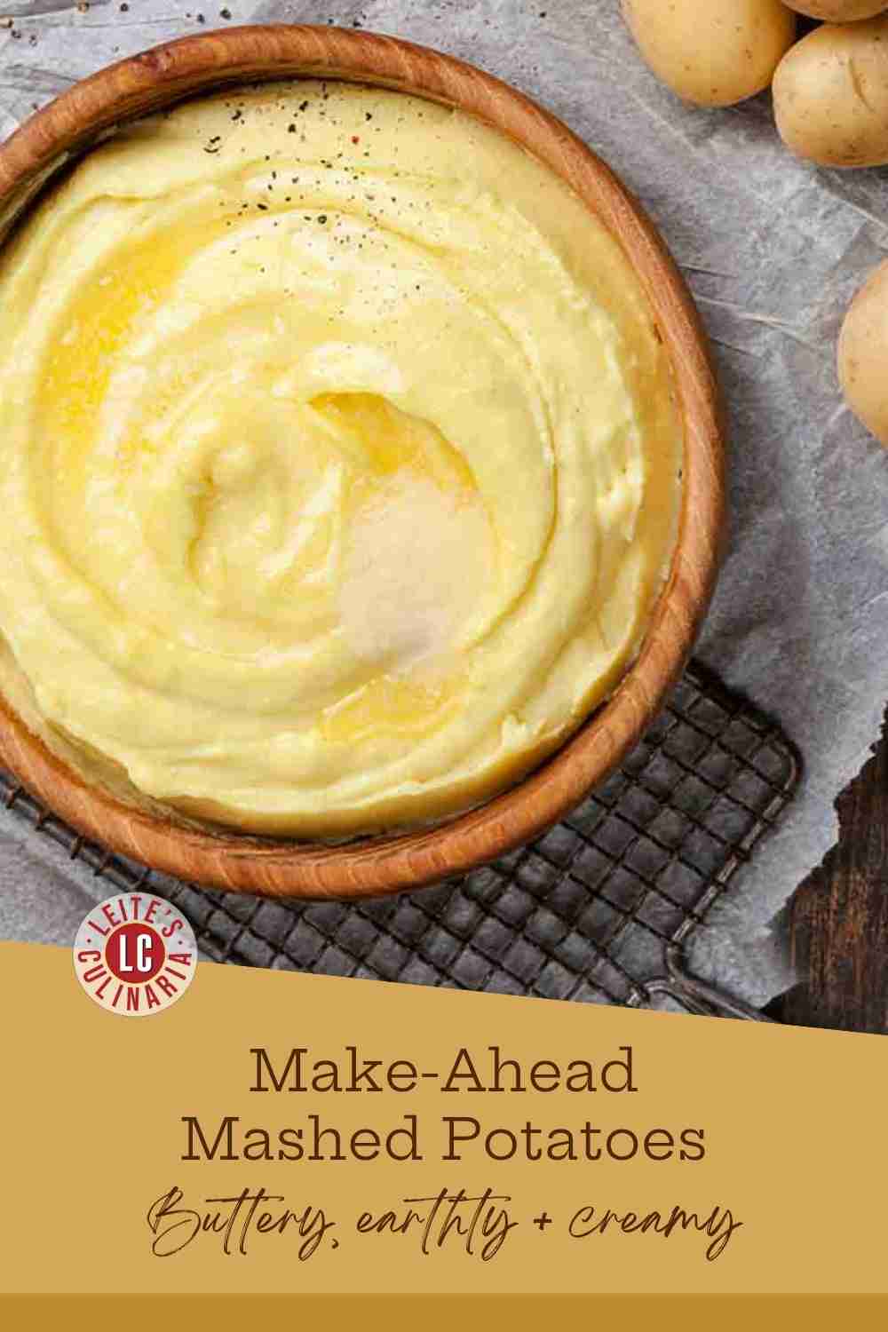 Creamy, smooth mashed potatoes topped with melted butter, salt, and pepper in a wooden bowl.
