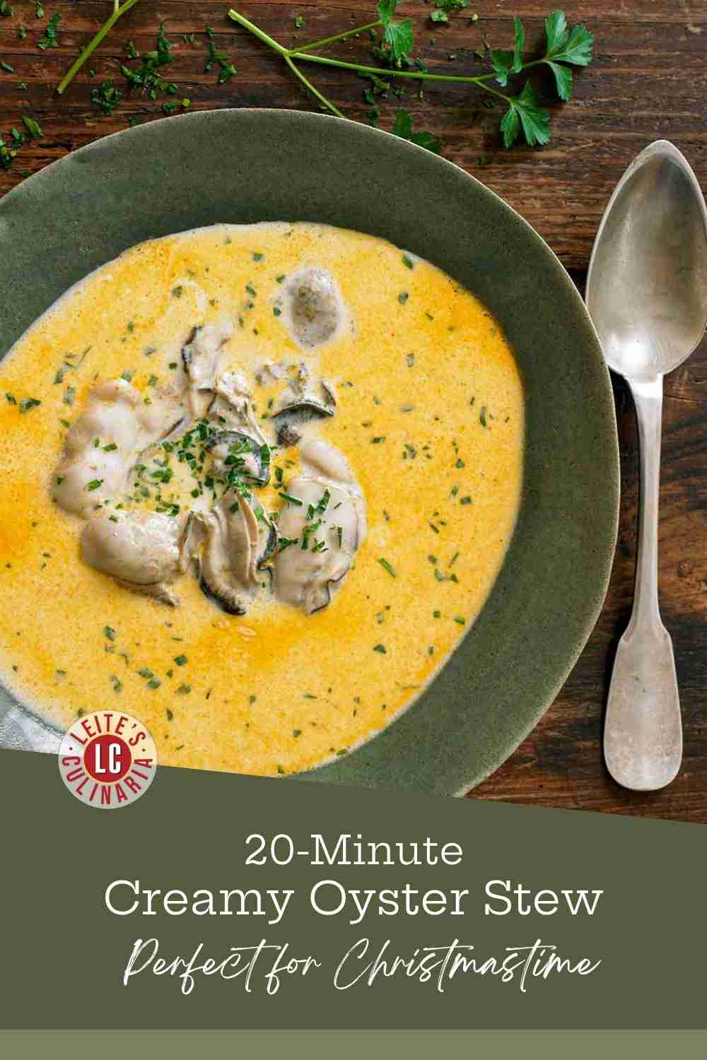 A green ceramic bowl of creamy oyster stew with whole oysters, seasoned with paprika and garnished with fresh parsley.