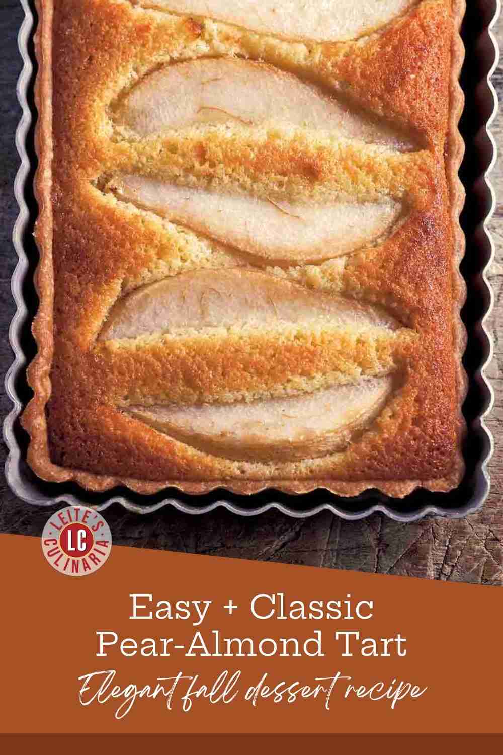 Close-up of a rustic, golden-brown almond frangipane tart with tender baked pear wedges on a table.