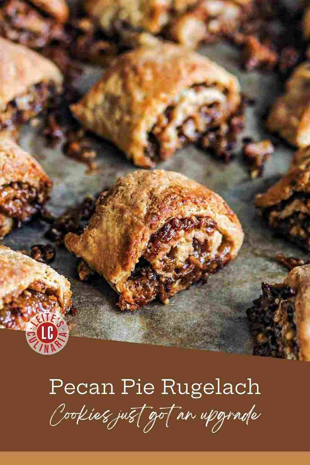 Baked spiral-cut cream cheese dough, filled with a dark pecan pie mixture, rests on a baking baking sheet.