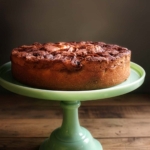 Super moist apple cake on a jadeite cake stand.